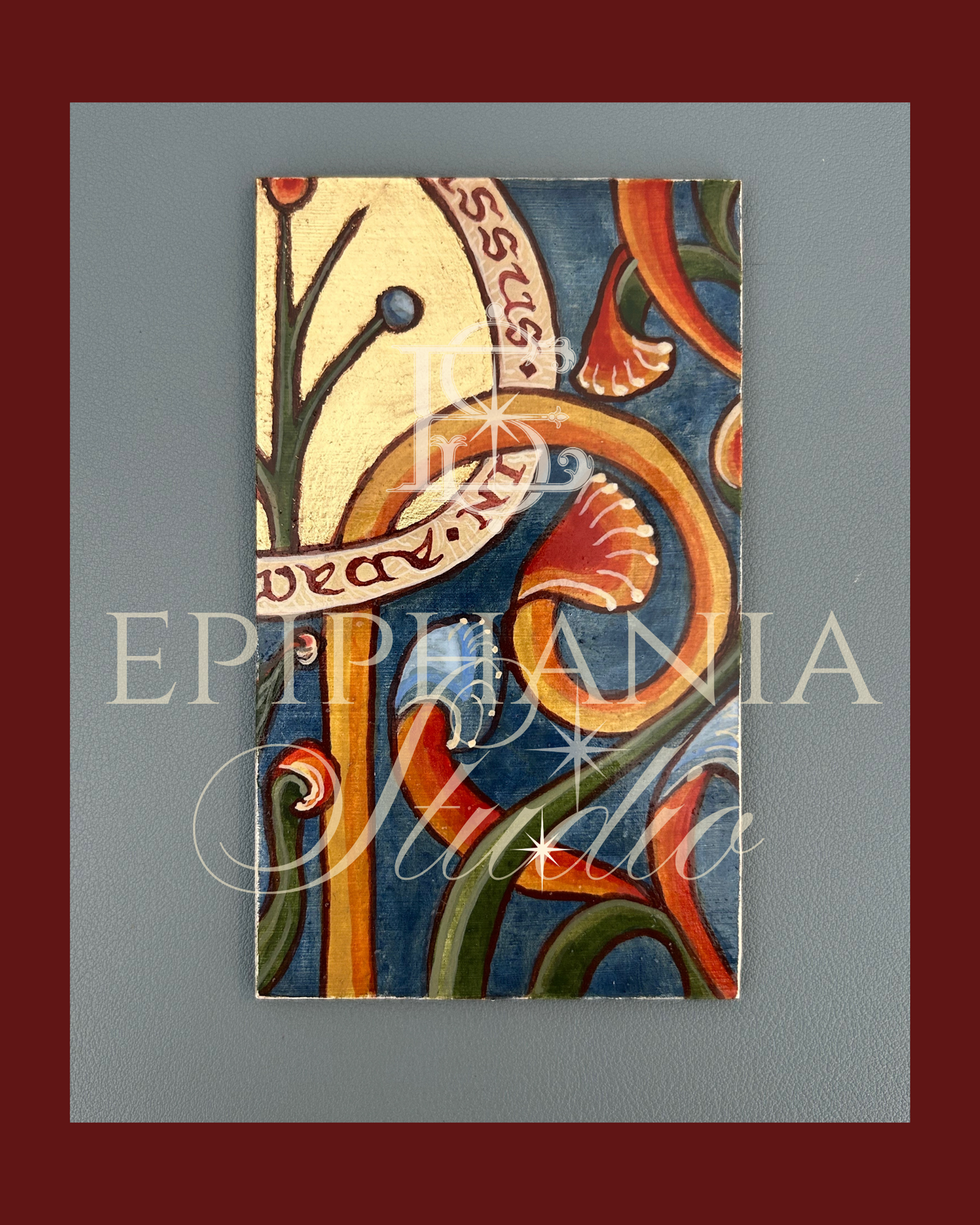 Decorative painting with floral patterns and latin words on a blue background, featuring the watermark 'Epiphania Studio'.