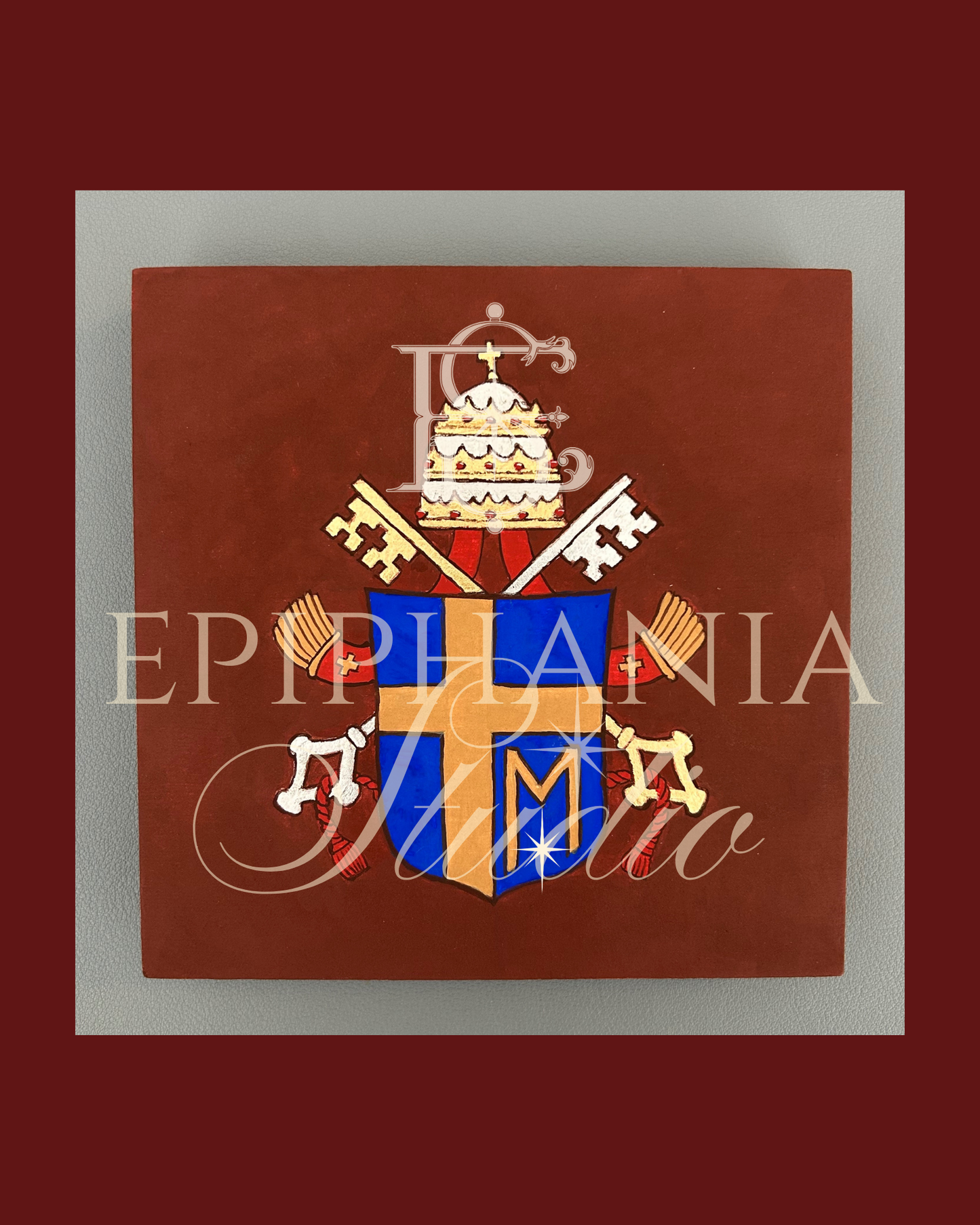 Coat of arms of St. Pope John Paul II with keys and a M motif on a red background, featuring the watermark 'Epiphania Studio'.