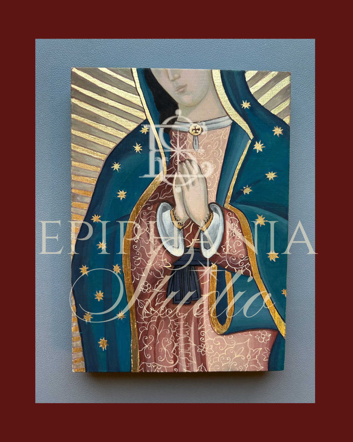 Artistic depiction of a religious figure with a blue and gold background, featuring the brand watermark 'Epiphania Studio'.
