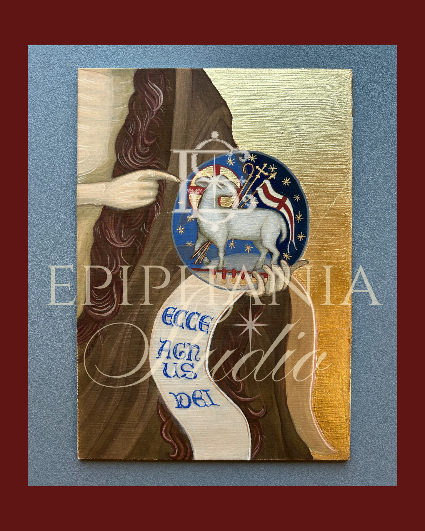 Artistic depiction of a figure of St. John the Baptist holding an orb with the Lamb of God, text, and gold and paint colored decorative elements on a blue background.